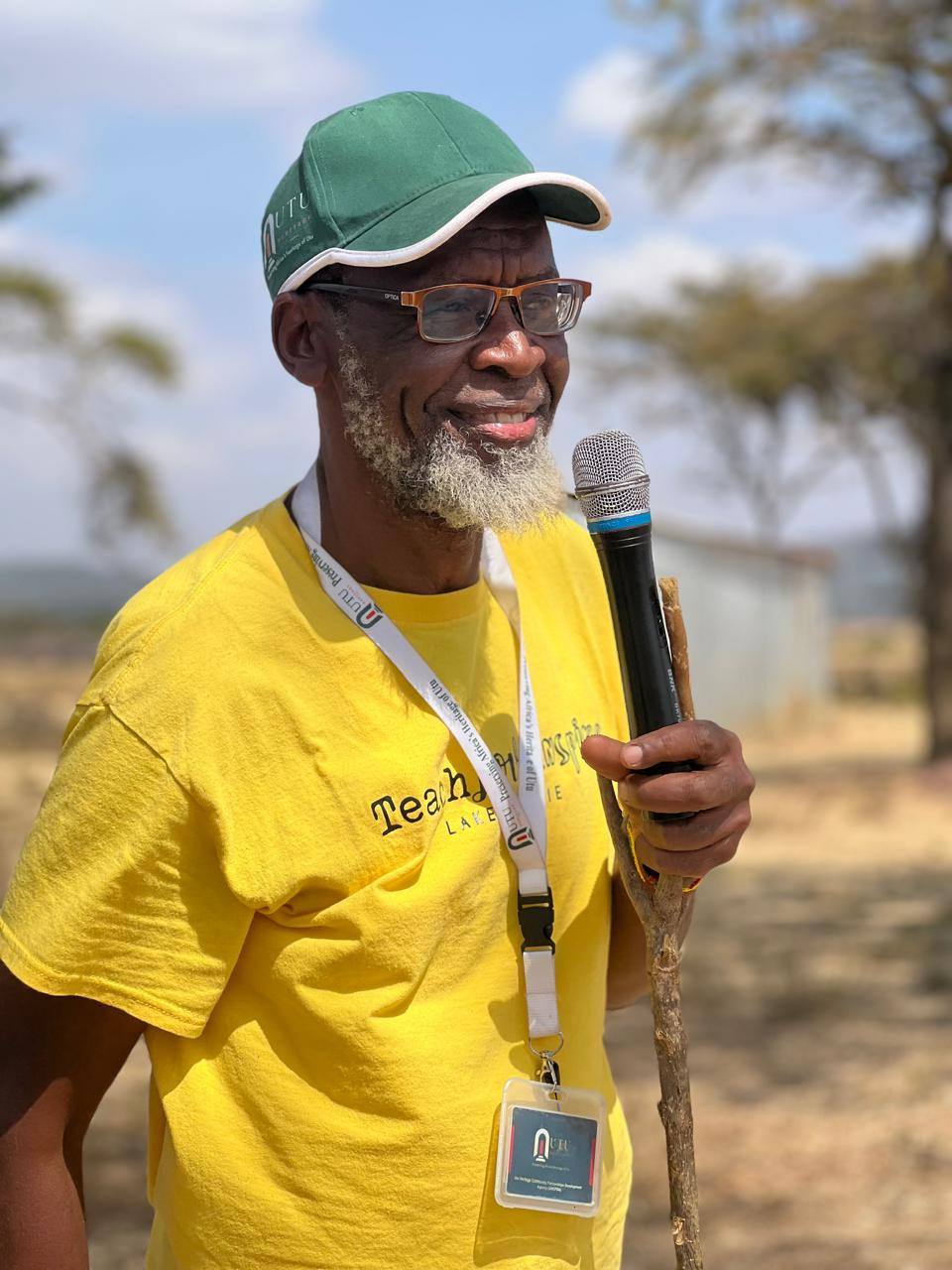 Al-Amin Kimathi (Babu) speaking with a microphone at a community gathering