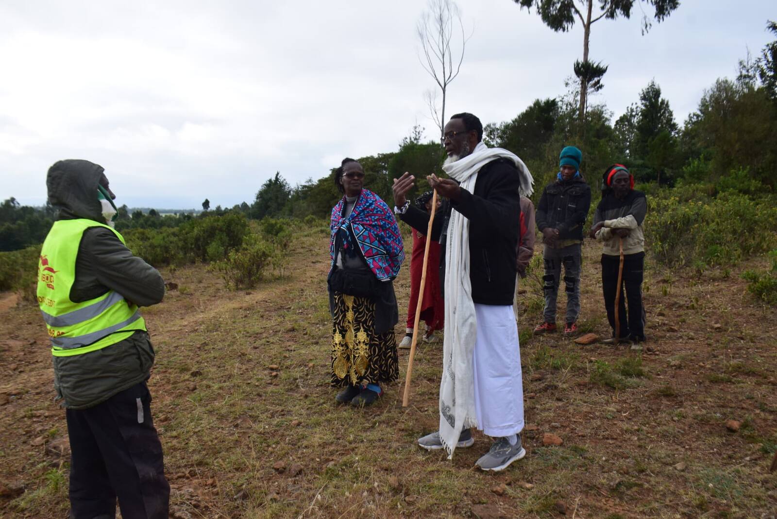 Al-Amin Kimathi addressing community custodians on a forested ridge
