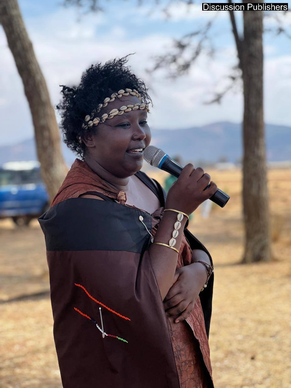 Juliana addressing the Sieku gathering with a microphone