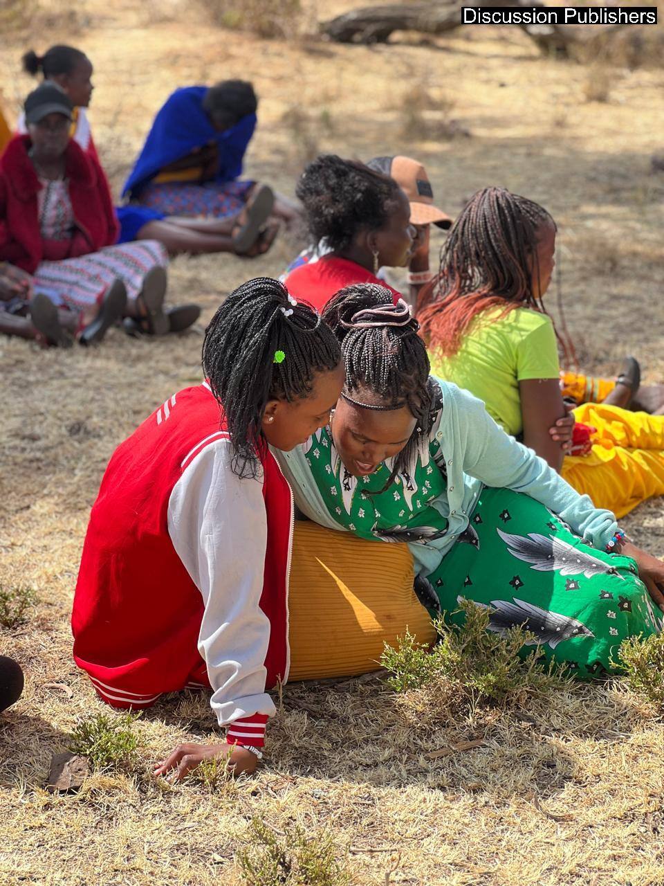 Two young women in conversation during a community heritage session